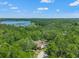 Aerial view of home and surroundings with a lake in the distance at 25487 Dan Brown Hill Rd, Brooksville, FL 34602