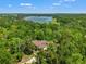 Stunning aerial view of a lakeside home surrounded by lush greenery and beautiful natural landscape at 25487 Dan Brown Hill Rd, Brooksville, FL 34602