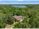 Beautiful aerial view of a sprawling home surrounded by lush trees, highlighting the home's privacy and scenic location at 25487 Dan Brown Hill Rd, Brooksville, FL 34602