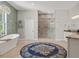 Luxurious bathroom with a soaking tub, glass shower, and decorative rug at 25487 Dan Brown Hill Rd, Brooksville, FL 34602