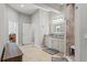 Bright bathroom featuring a double vanity, neutral tile floor, and a glass-enclosed shower with tiled accents at 25487 Dan Brown Hill Rd, Brooksville, FL 34602