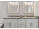 Bathroom featuring double vanity with granite countertop, framed mirrors and updated fixtures at 25487 Dan Brown Hill Rd, Brooksville, FL 34602