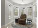 This sunlit room features a bay window, a comfortable recliner, and tasteful furnishings at 25487 Dan Brown Hill Rd, Brooksville, FL 34602