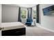 Bedroom with large windows, and a blue accent chair at 25487 Dan Brown Hill Rd, Brooksville, FL 34602