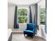 Bedroom with large windows, and a blue accent chair at 25487 Dan Brown Hill Rd, Brooksville, FL 34602