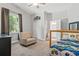 Bedroom with large window, closet, connecting bathroom, and ceiling fan at 25487 Dan Brown Hill Rd, Brooksville, FL 34602