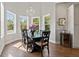 Elegant dining area with natural light, chandelier, and a dark wood table with seating at 25487 Dan Brown Hill Rd, Brooksville, FL 34602