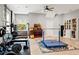 Spacious home gym includes free weights, weight rack, bookcase and adjacent stairs at 25487 Dan Brown Hill Rd, Brooksville, FL 34602