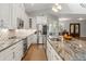 Bright kitchen featuring custom cabinets, stainless steel appliances, and a granite countertop island with sink at 25487 Dan Brown Hill Rd, Brooksville, FL 34602