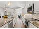 Modern kitchen with granite countertops, stainless steel appliances, and island sink at 25487 Dan Brown Hill Rd, Brooksville, FL 34602