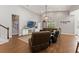 Bright living room with hardwood floors, a large entertainment center, and a comfortable leather sectional for relaxing at 25487 Dan Brown Hill Rd, Brooksville, FL 34602
