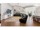 Spacious living room with hardwood floors, vaulted ceilings, and natural light, seamlessly flowing into the dining area at 25487 Dan Brown Hill Rd, Brooksville, FL 34602