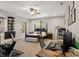 Spacious main bedroom with a four-poster bed, a ceiling fan, and a home office at 25487 Dan Brown Hill Rd, Brooksville, FL 34602