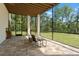 Covered patio featuring outdoor seating and views of the lawn, mature trees, and a fenced-in pool at 25487 Dan Brown Hill Rd, Brooksville, FL 34602