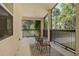 View of the screened-in patio with outdoor furniture overlooking the backyard at 25487 Dan Brown Hill Rd, Brooksville, FL 34602