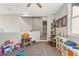 Upper level playroom features neutral walls, ceiling fan, and doorway with natural light at 25487 Dan Brown Hill Rd, Brooksville, FL 34602