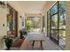 Inviting screened-in front porch with comfortable seating, offering a peaceful transition from outdoors to indoors at 25487 Dan Brown Hill Rd, Brooksville, FL 34602