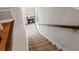 View of the stairway with carpet and wood railing at 25487 Dan Brown Hill Rd, Brooksville, FL 34602