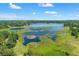 Expansive aerial view showcases the lake and lush wetlands at 25487 Dan Brown Hill Rd, Brooksville, FL 34602