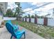 Spacious backyard with blue chairs and a white and red brick fence at 2954 Leisure Ct, Dunedin, FL 34698