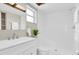 Clean bathroom with new vanity, tiled shower, white sink, and skylight providing natural light at 2954 Leisure Ct, Dunedin, FL 34698