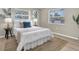 Inviting bedroom with neutral tones, soft bedding, and natural light creating a serene and relaxing ambiance at 2954 Leisure Ct, Dunedin, FL 34698