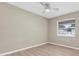 Neutral bedroom with good light, window, and wood-look flooring at 2954 Leisure Ct, Dunedin, FL 34698