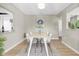 Bright dining room with natural wood table, white chairs, and contemporary decor at 2954 Leisure Ct, Dunedin, FL 34698