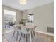 Bright dining area features modern table with white chairs and stylish chandelier, open to the living room at 2954 Leisure Ct, Dunedin, FL 34698