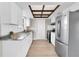 Modern kitchen featuring white cabinets, granite countertops, and stainless steel appliances at 2954 Leisure Ct, Dunedin, FL 34698