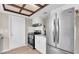 Sleek kitchen with stainless steel appliances, including a refrigerator and range, complemented by white cabinetry at 2954 Leisure Ct, Dunedin, FL 34698