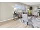 Cozy living room with a large window, neutral-toned furniture, and a stylish area rug over wood flooring at 2954 Leisure Ct, Dunedin, FL 34698