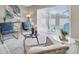 Cozy living room with comfortable blue chairs, area rug, and sliding glass doors leading to the outside at 2954 Leisure Ct, Dunedin, FL 34698