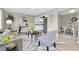 Bright living room featuring modern decor, a view into the updated kitchen and an adjacent dining area at 2954 Leisure Ct, Dunedin, FL 34698