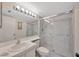Well-lit bathroom with a glass-enclosed shower, a vanity with a sink, and a large mirror offering functionality at 3134 Lake Pine Way # F2, Tarpon Springs, FL 34688