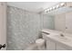 Clean bathroom featuring a vanity with a white sink, toilet, updated lighting, and neutral color tones at 3134 Lake Pine Way # F2, Tarpon Springs, FL 34688