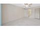 Bedroom with carpet, ceiling fan, closet, and en-suite bathroom access offering comfort and functionality at 3134 Lake Pine Way # F2, Tarpon Springs, FL 34688