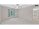 Spacious bedroom with soft carpeting, a ceiling fan, and a window for natural light and ventilation at 3134 Lake Pine Way # F2, Tarpon Springs, FL 34688