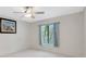 Inviting bedroom featuring a ceiling fan, a window with curtains, and neutral tones for a cozy atmosphere at 3134 Lake Pine Way # F2, Tarpon Springs, FL 34688