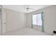 Bright bedroom with a ceiling fan, a window, and a closet offering a comfortable and functional living space at 3134 Lake Pine Way # F2, Tarpon Springs, FL 34688