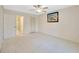 Comfortable bedroom with carpet, ceiling fan, closet, and en-suite bathroom access for convenience and privacy at 3134 Lake Pine Way # F2, Tarpon Springs, FL 34688