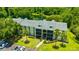 Condo building with beautiful landscaping, pond view, and ample parking at 3134 Lake Pine Way # F2, Tarpon Springs, FL 34688