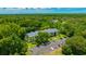 Exterior aerial view of the condos showing the well maintained grounds and lush trees at 3134 Lake Pine Way # F2, Tarpon Springs, FL 34688