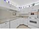 Bright kitchen featuring white cabinetry, modern appliances, and ample counter space for cooking and entertaining at 3134 Lake Pine Way # F2, Tarpon Springs, FL 34688