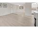 Living room with hardwood floors, fireplace, and view into kitchen at 3134 Lake Pine Way # F2, Tarpon Springs, FL 34688