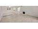 Spacious living room with hardwood floors, decorative fireplace, and view into kitchen at 3134 Lake Pine Way # F2, Tarpon Springs, FL 34688