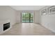 Open living room area with new floors and decorative fireplace at 3134 Lake Pine Way # F2, Tarpon Springs, FL 34688