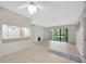 Open floorplan with large living room, decorative fireplace, and access to kitchen at 3134 Lake Pine Way # F2, Tarpon Springs, FL 34688