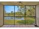 Screened patio with a view of a lake with trees and black metal railings at 3134 Lake Pine Way # F2, Tarpon Springs, FL 34688
