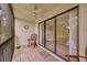 Screened patio with a ceiling fan, tile flooring, and a view of the community landscape with wicker furniture at 3134 Lake Pine Way # F2, Tarpon Springs, FL 34688